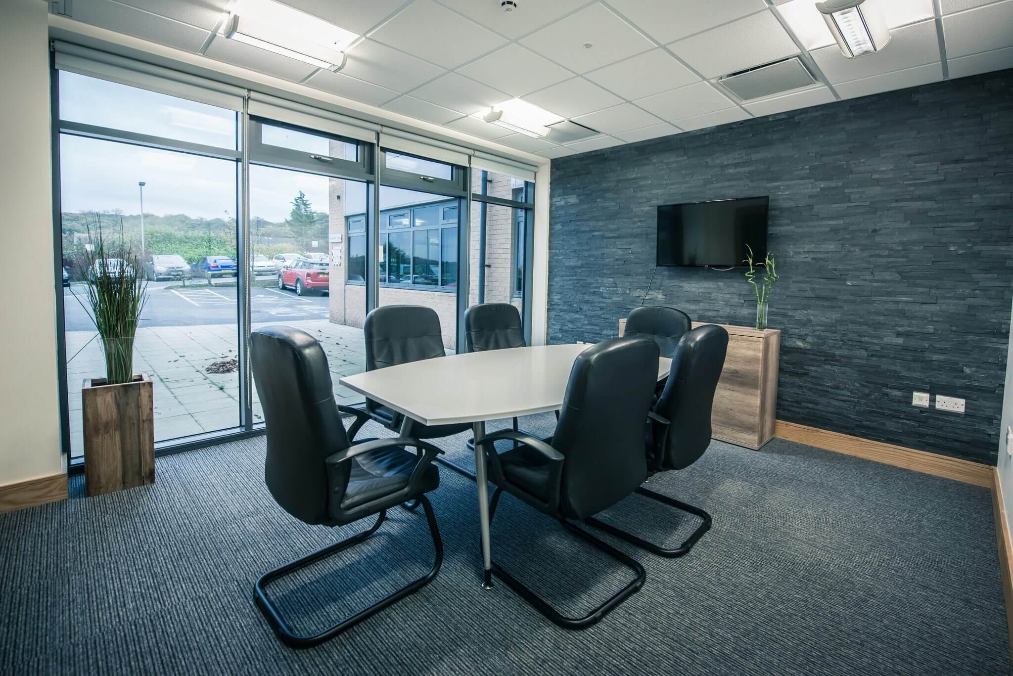 The Wood meeting room at City Gateway Bradford with a boardroom-style table and screen