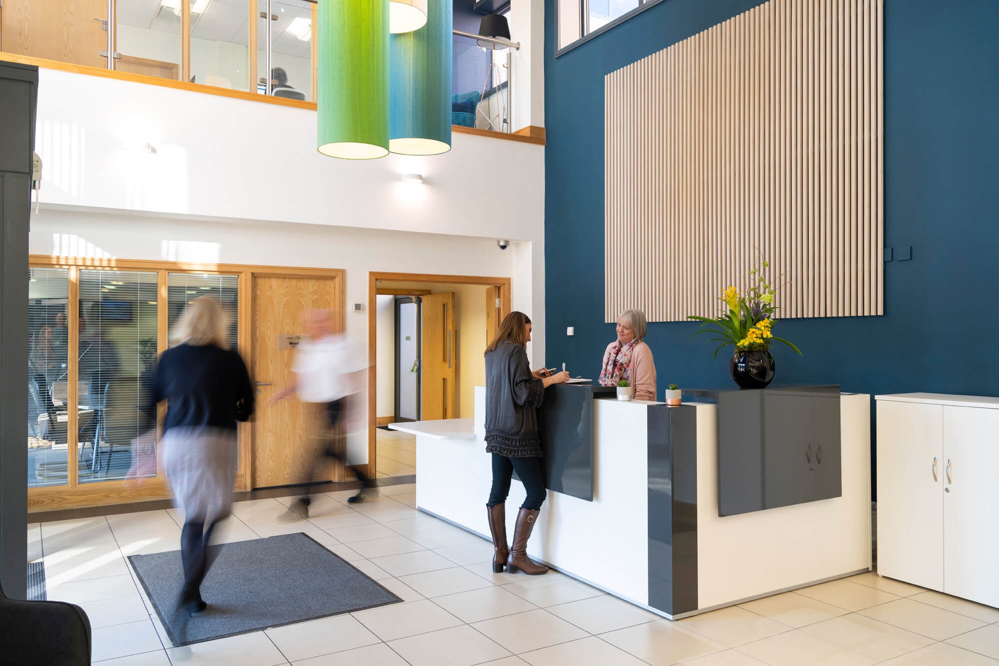 The atrium reception at Hope Park, with people walking through a bright, double-height lobby