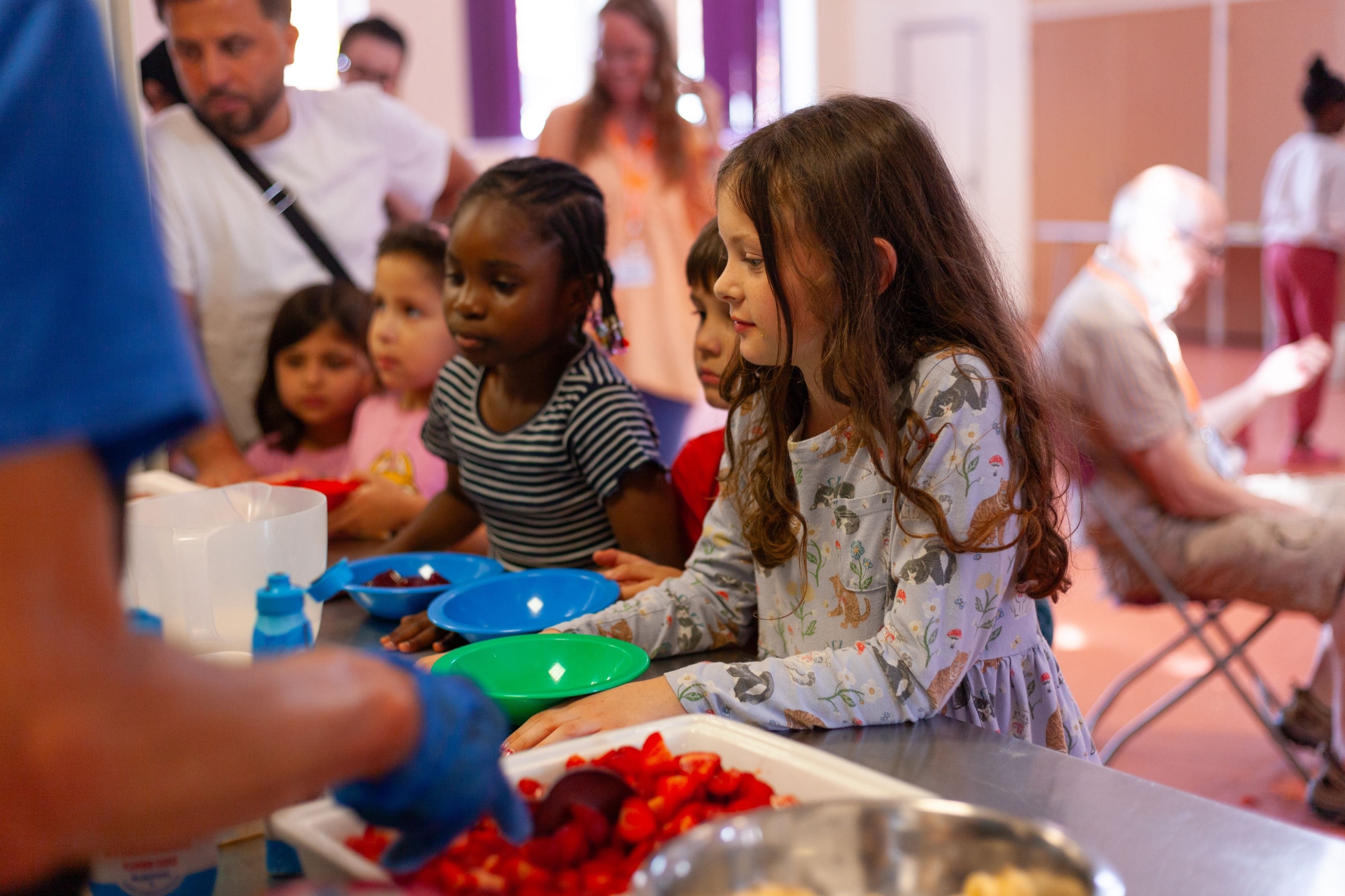 Children at a community mealtime — one of the TLG initiatives Hope Park profits help fund